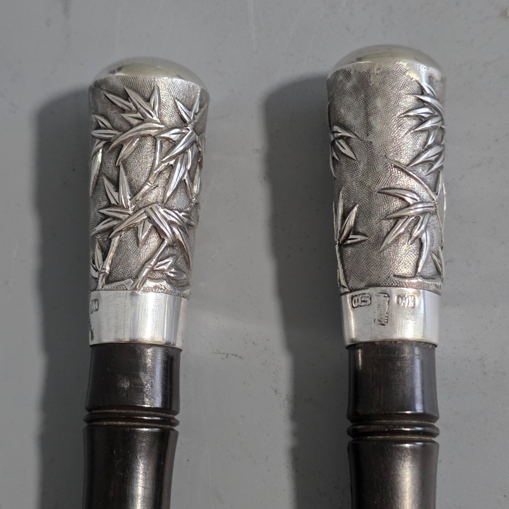 A pair of Chinese export silver salad servers featuring carved shell bowls, dark wooden bamboo-form handles, and silver terminal caps chased with bamboo leaves. View II