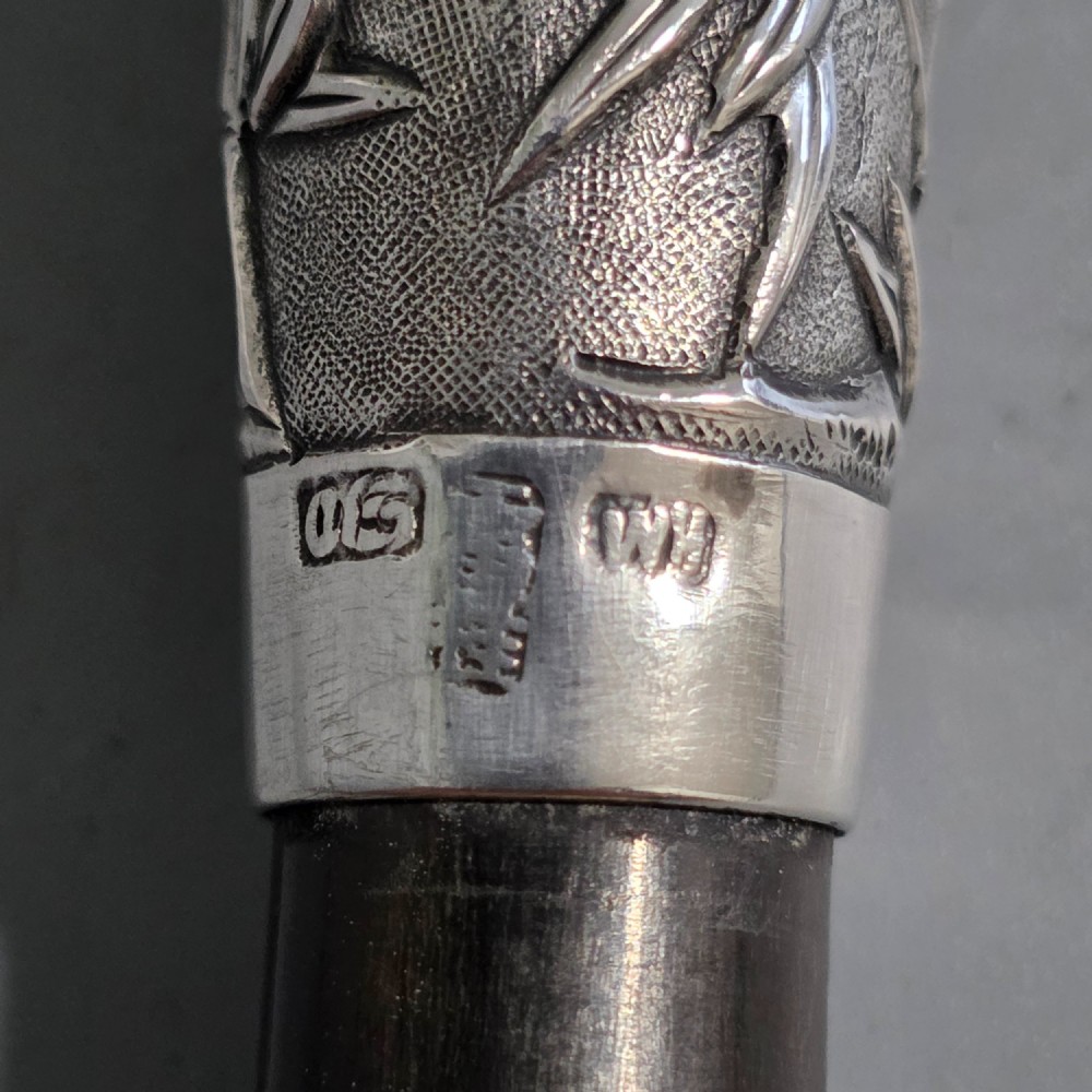 A pair of Chinese export silver salad servers featuring carved shell bowls, dark wooden bamboo-form handles, and silver terminal caps chased with bamboo leaves. View VII