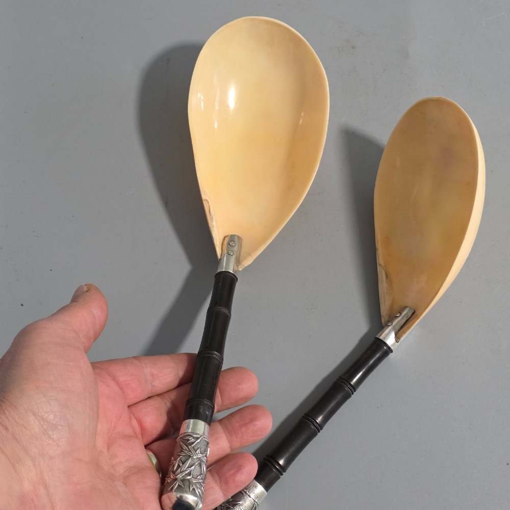 A pair of Chinese export silver salad servers featuring carved shell bowls, dark wooden bamboo-form handles, and silver terminal caps chased with bamboo leaves. View XI