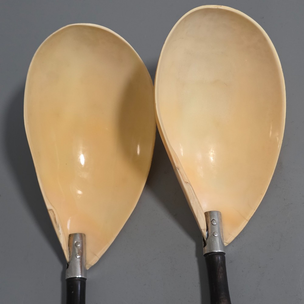 A pair of Chinese export silver salad servers featuring carved shell bowls, dark wooden bamboo-form handles, and silver terminal caps chased with bamboo leaves. View XIV
