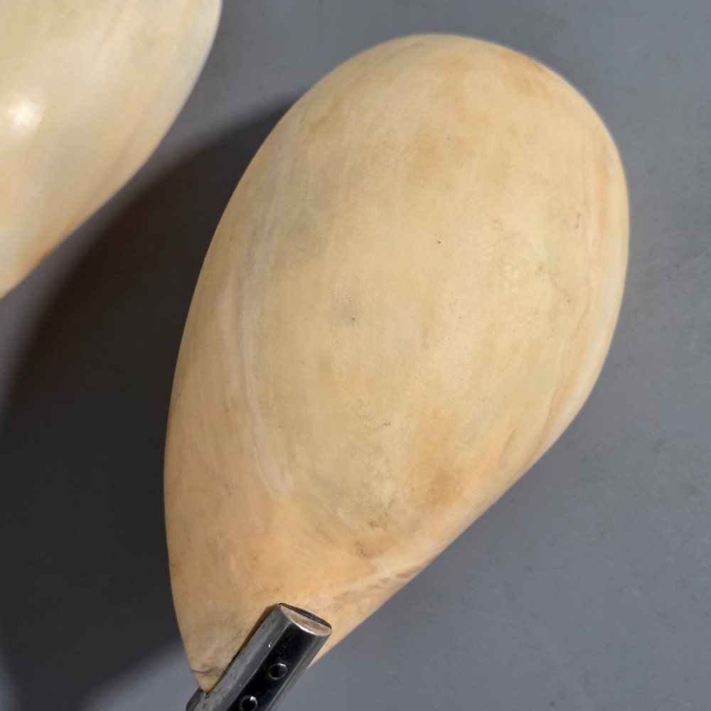 A pair of Chinese export silver salad servers featuring carved shell bowls, dark wooden bamboo-form handles, and silver terminal caps chased with bamboo leaves. View XV