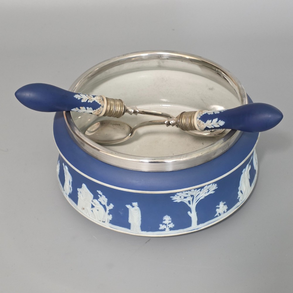 A Victorian Wedgwood blue jasperware salad bowl with a silver-plated rim, decorated with white neoclassical relief figures, complete with matching blue and silver servers. View IV