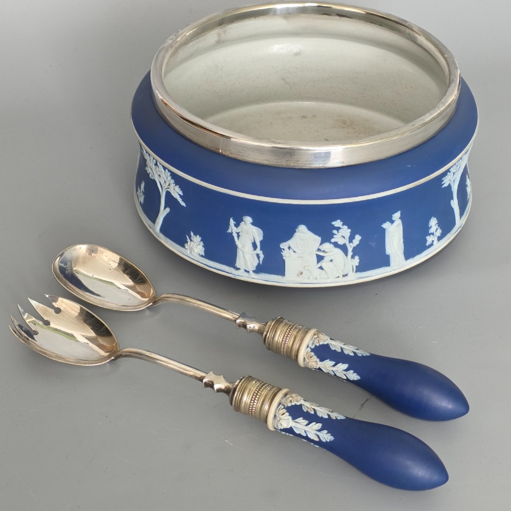 A Victorian Wedgwood blue jasperware salad bowl with a silver-plated rim, decorated with white neoclassical relief figures, complete with matching blue and silver servers. View IX