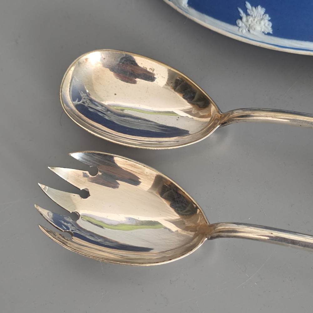 A Victorian Wedgwood blue jasperware salad bowl with a silver-plated rim, decorated with white neoclassical relief figures, complete with matching blue and silver servers. View XI