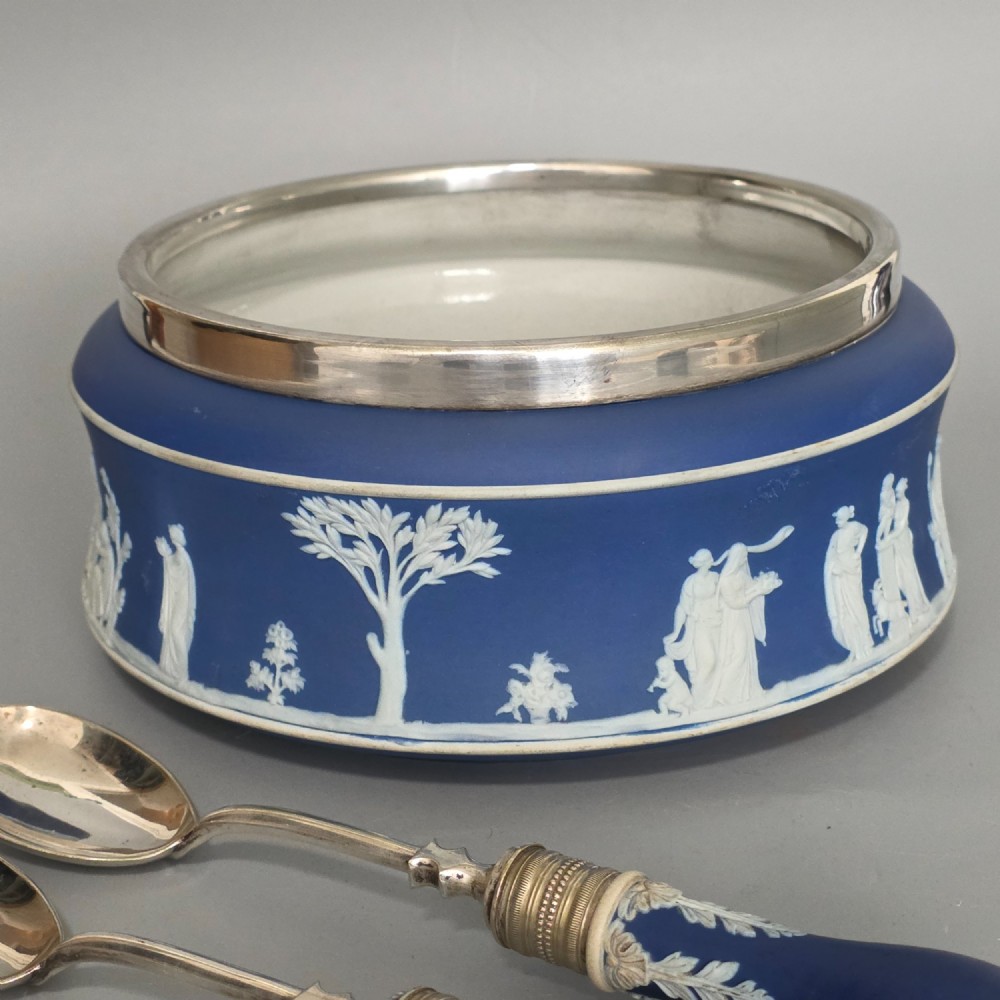 A Victorian Wedgwood blue jasperware salad bowl with a silver-plated rim, decorated with white neoclassical relief figures, complete with matching blue and silver servers. View XIII