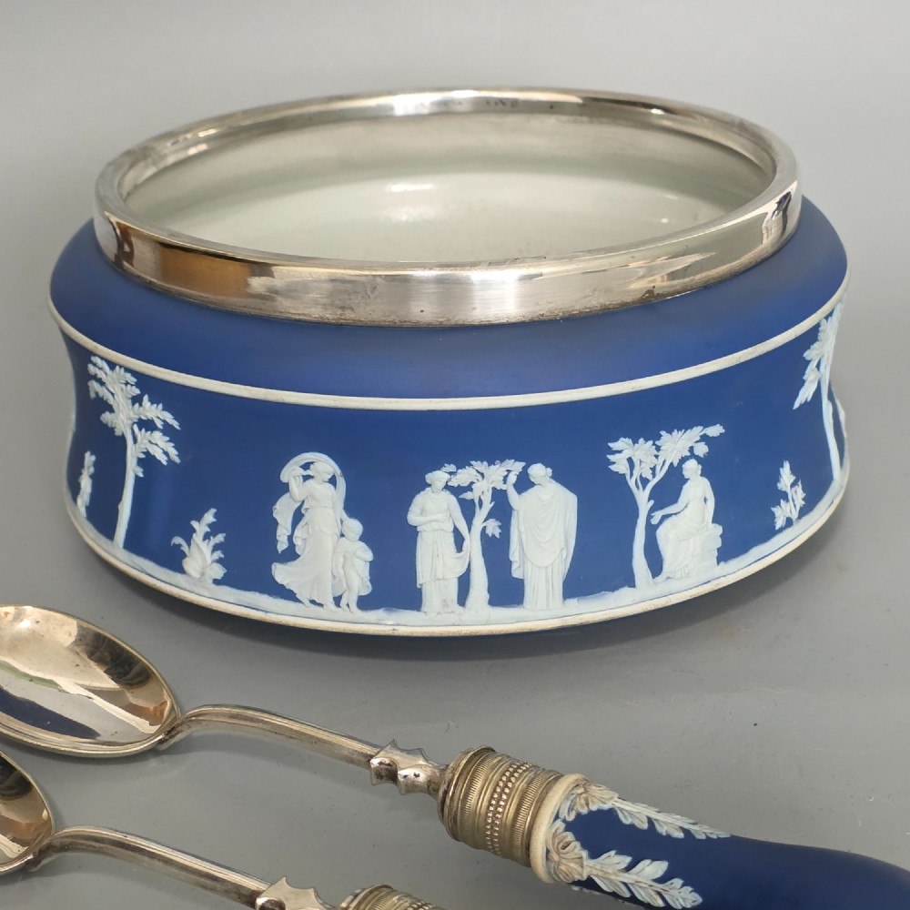 A Victorian Wedgwood blue jasperware salad bowl with a silver-plated rim, decorated with white neoclassical relief figures, complete with matching blue and silver servers. View XIV