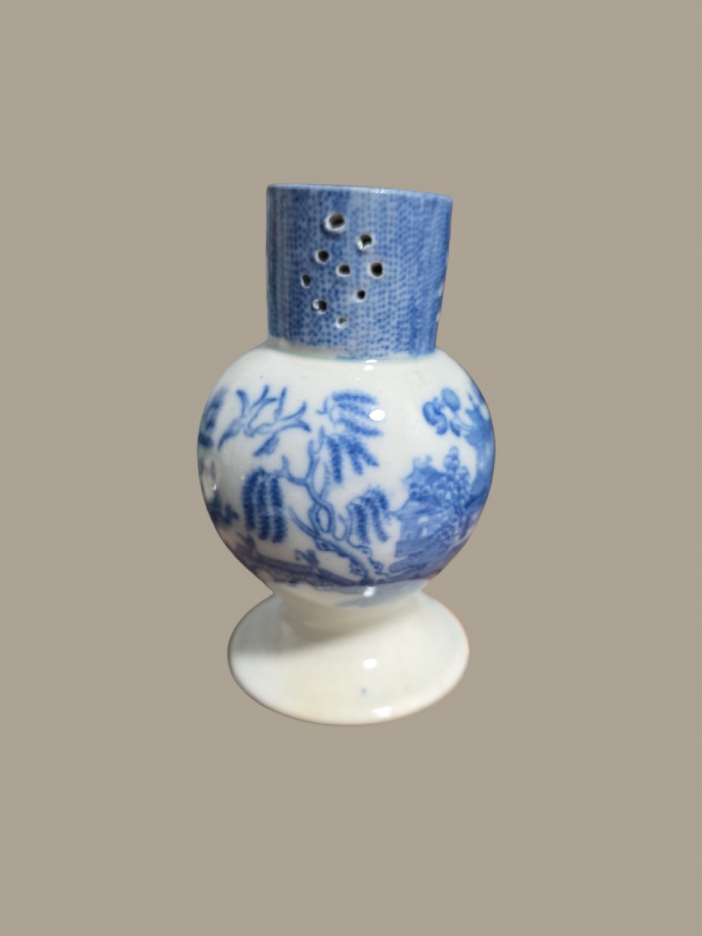An antique blue and white pearlware pepper pot featuring transfer-printed chinoiserie motifs and a perforated cylindrical top. View III