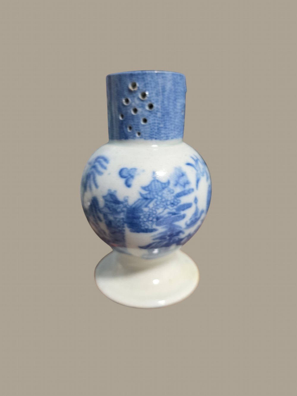 An antique blue and white pearlware pepper pot featuring transfer-printed chinoiserie motifs and a perforated cylindrical top. View VII