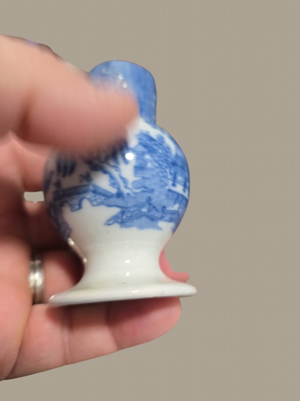 An antique blue and white pearlware pepper pot featuring transfer-printed chinoiserie motifs and a perforated cylindrical top. View VIII