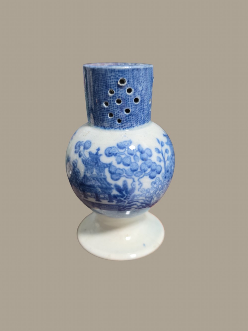 An antique blue and white pearlware pepper pot featuring transfer-printed chinoiserie motifs and a perforated cylindrical top. View IX