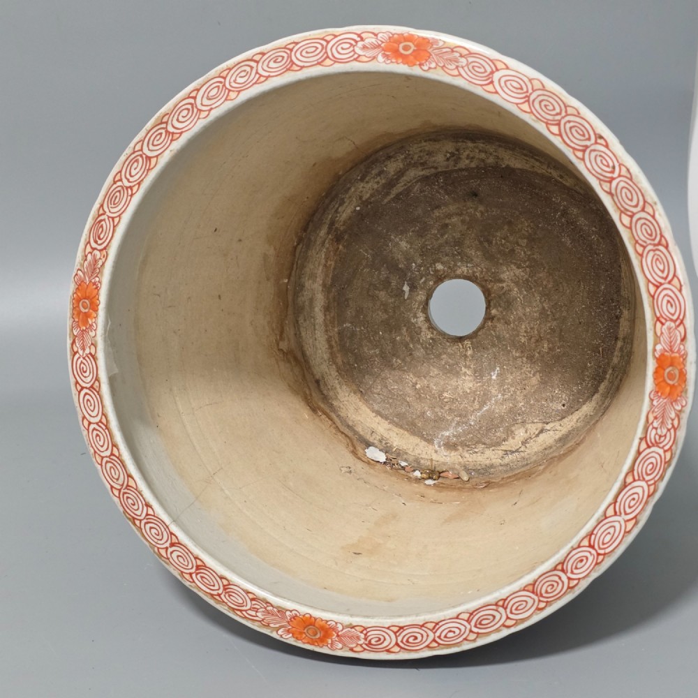 A late 19th-century Japanese Imari porcelain planter decorated with cobalt blue and iron-red floral basket panels, resting on a carved dark wood stand. View XIII