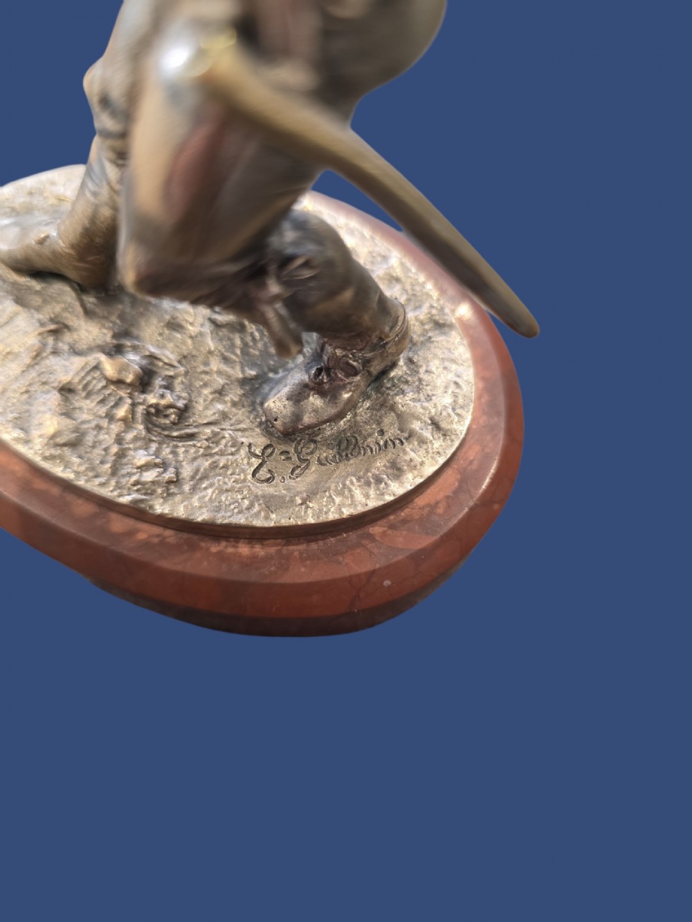 A nineteenth-century silvered bronze sculpture depicting a sword-wielding cavalier posed on an oval rouge marble plinth. View II