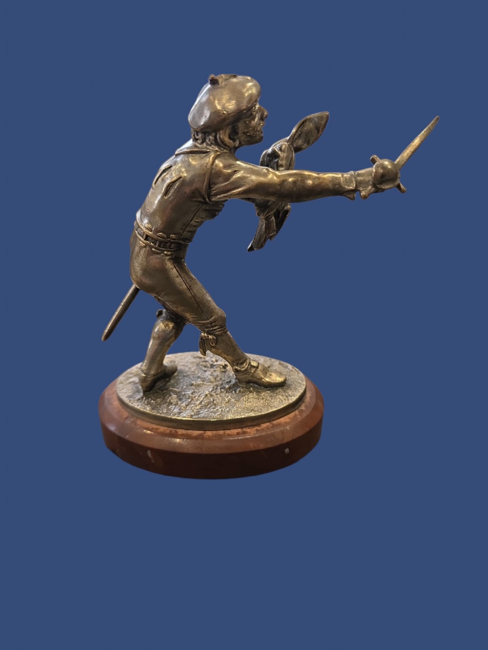 A nineteenth-century silvered bronze sculpture depicting a sword-wielding cavalier posed on an oval rouge marble plinth. View III