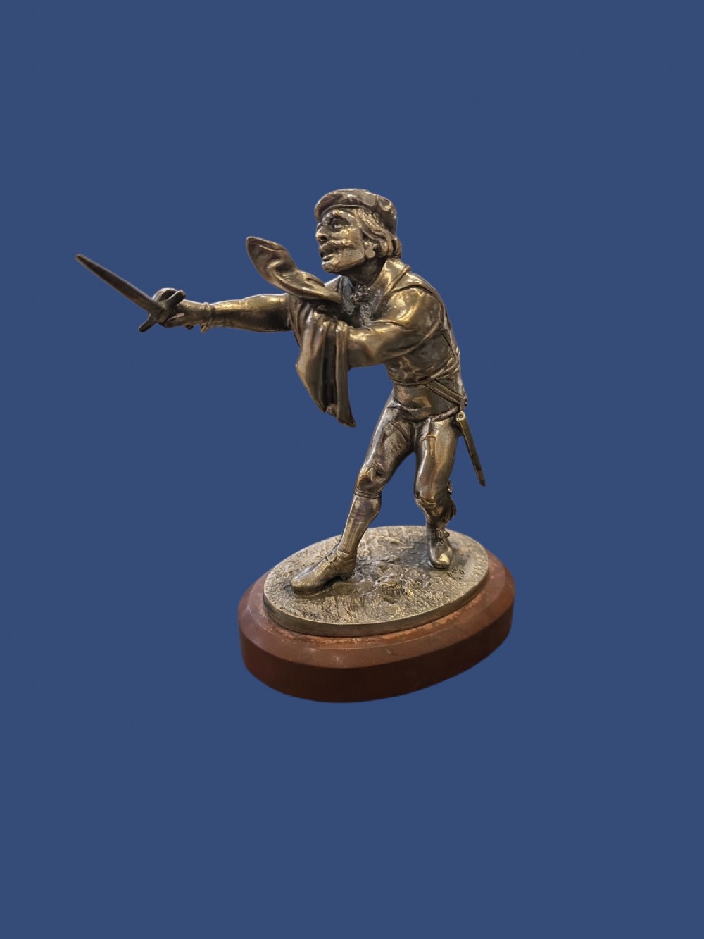A nineteenth-century silvered bronze sculpture depicting a sword-wielding cavalier posed on an oval rouge marble plinth. View IV