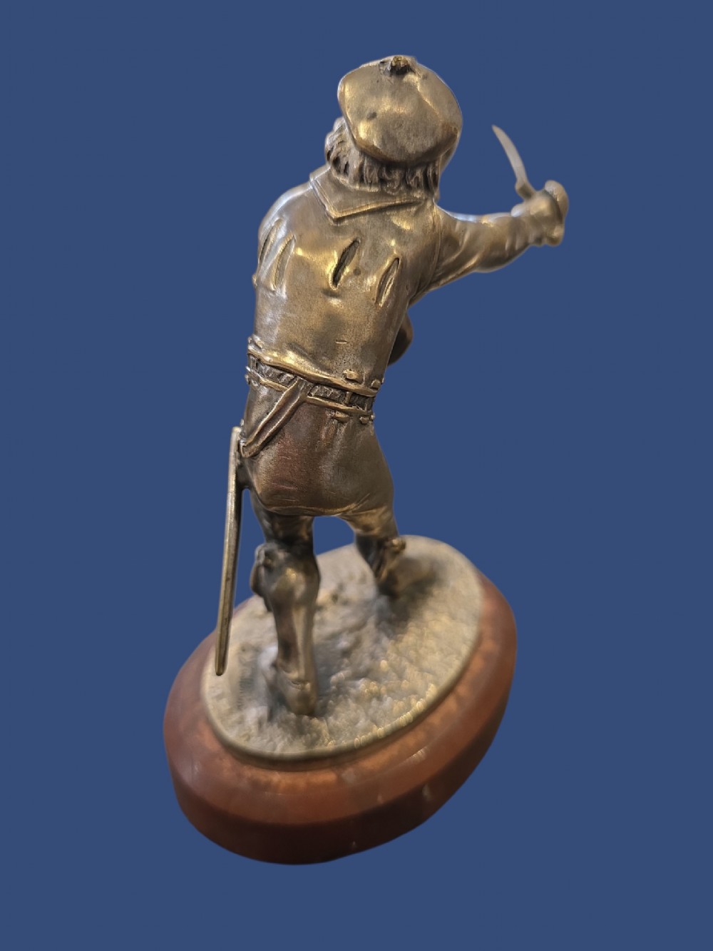 A nineteenth-century silvered bronze sculpture depicting a sword-wielding cavalier posed on an oval rouge marble plinth. View VI