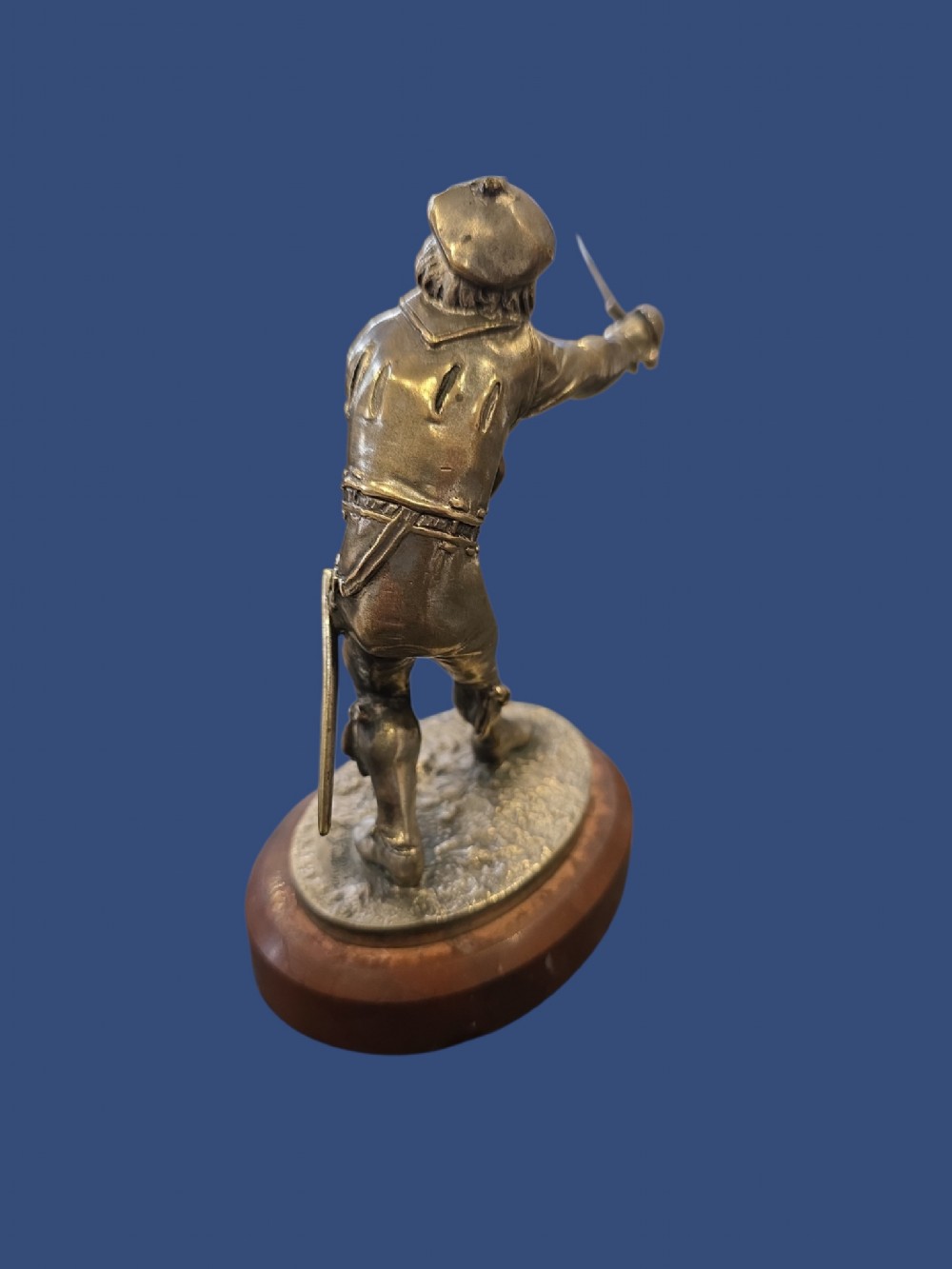 A nineteenth-century silvered bronze sculpture depicting a sword-wielding cavalier posed on an oval rouge marble plinth. View VIII