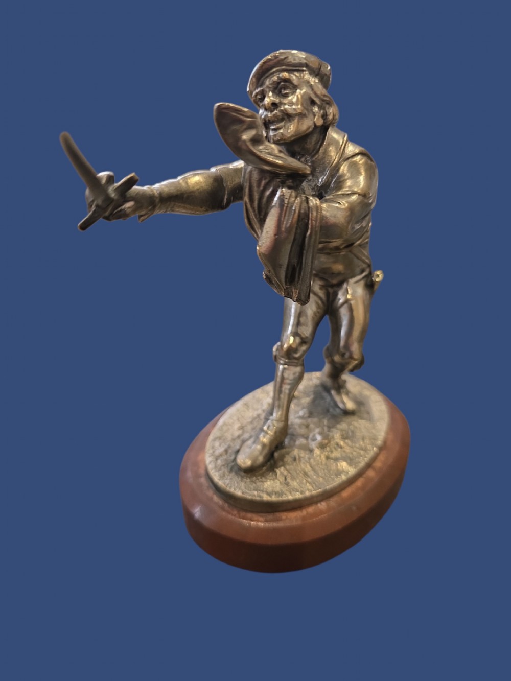 A nineteenth-century silvered bronze sculpture depicting a sword-wielding cavalier posed on an oval rouge marble plinth. View X