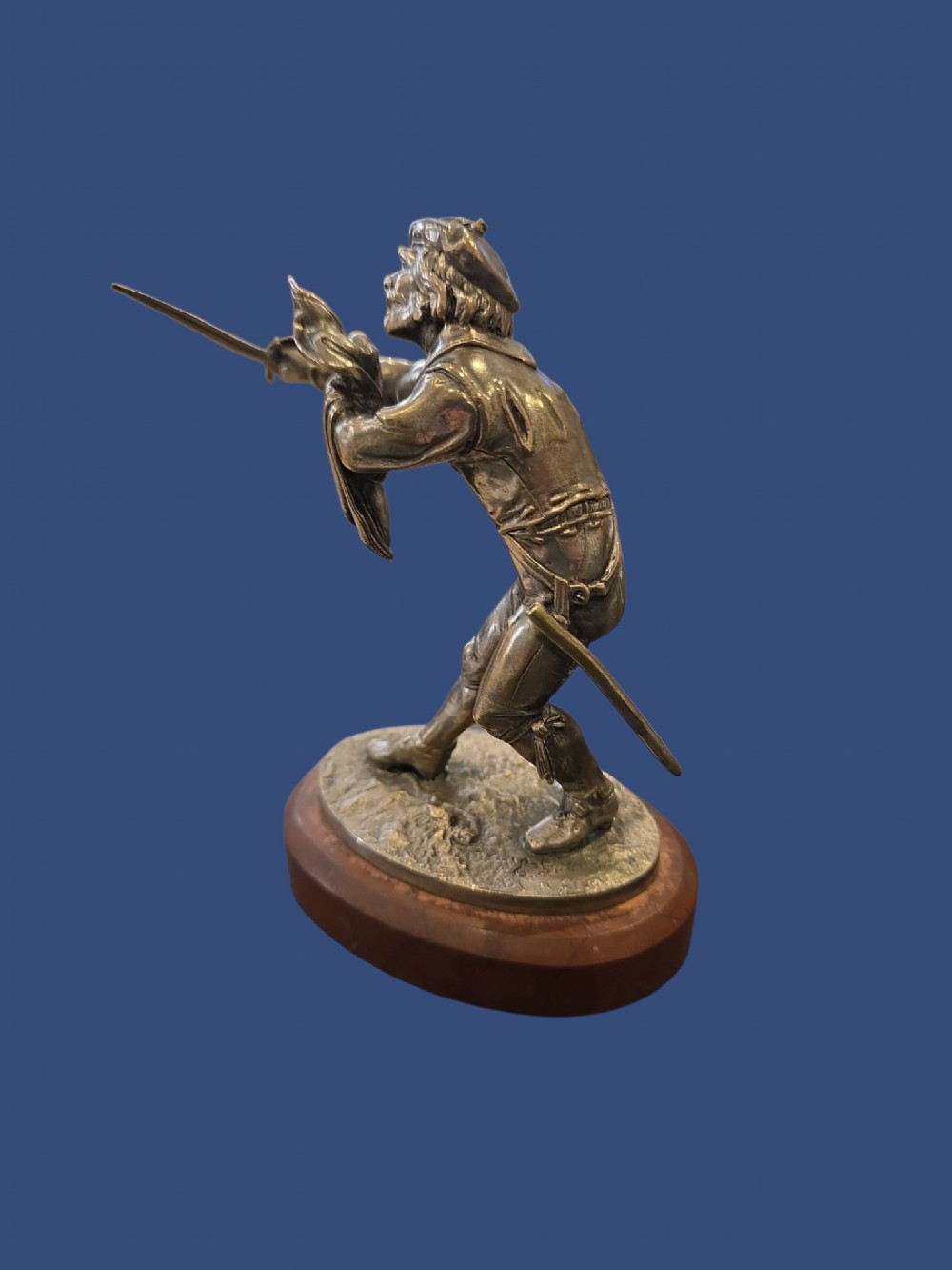A nineteenth-century silvered bronze sculpture depicting a sword-wielding cavalier posed on an oval rouge marble plinth. View XI