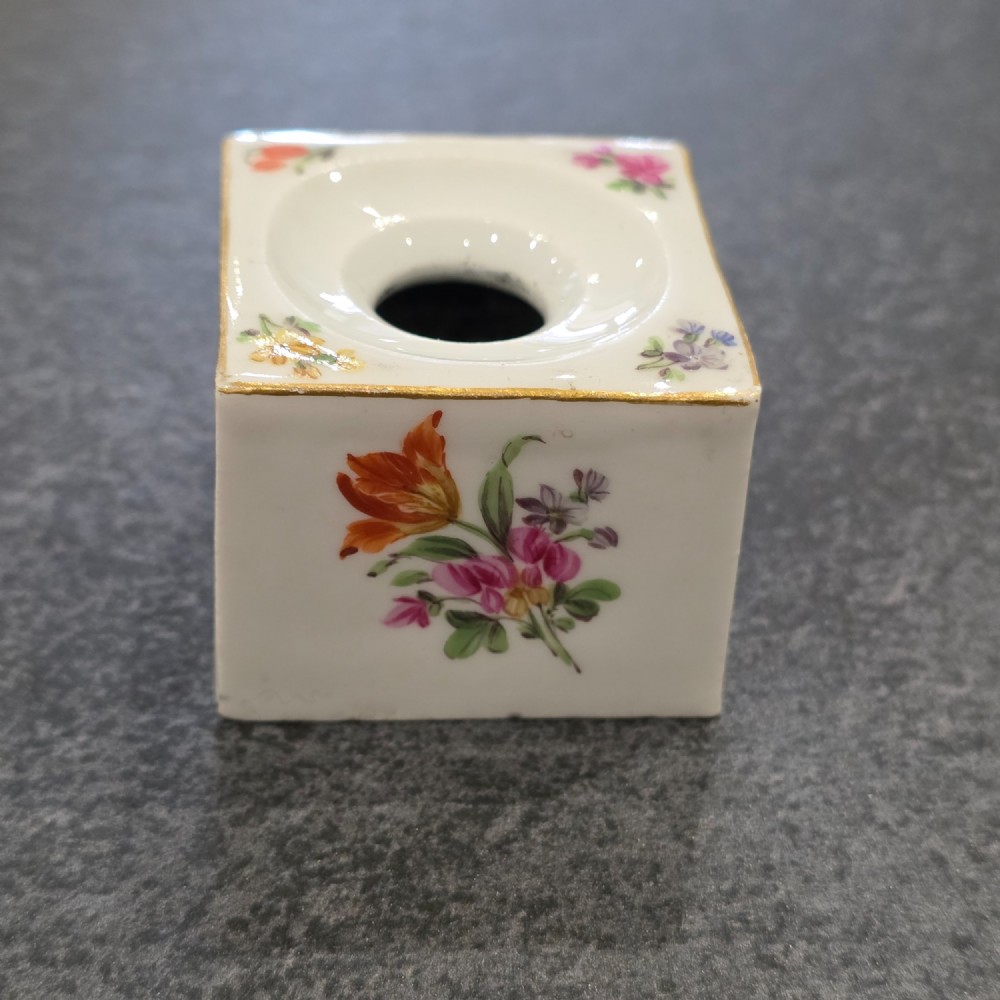 A square white porcelain inkwell featuring a recessed circular top, hand-painted botanical flowers on the sides, and a gold gilded rim. View IV