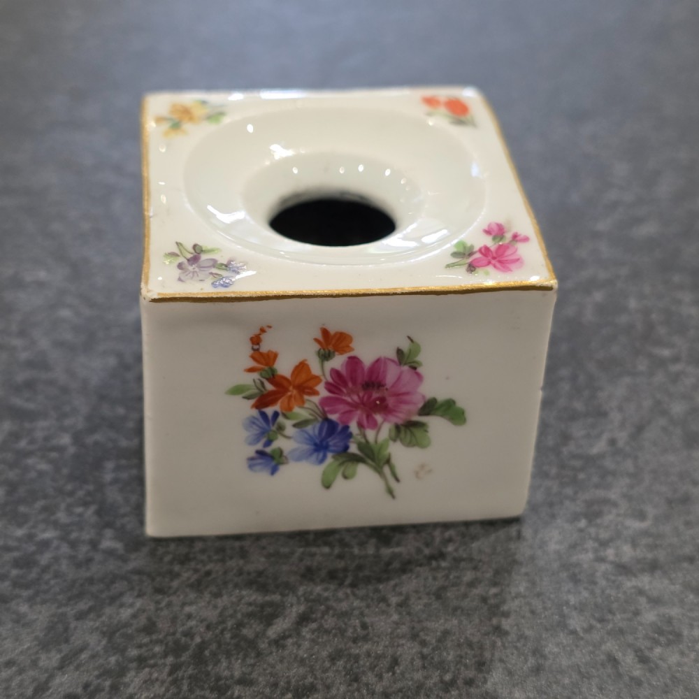 A square white porcelain inkwell featuring a recessed circular top, hand-painted botanical flowers on the sides, and a gold gilded rim. View V