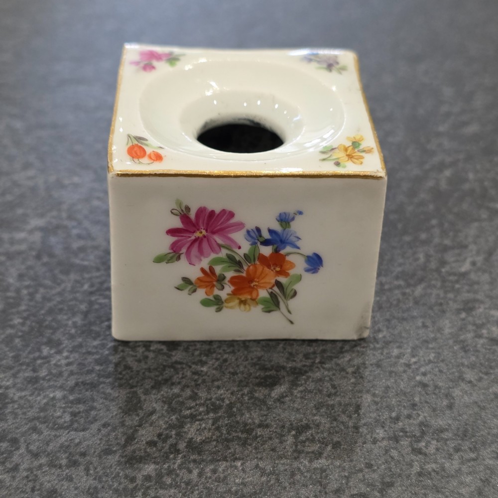 A square white porcelain inkwell featuring a recessed circular top, hand-painted botanical flowers on the sides, and a gold gilded rim. View VII