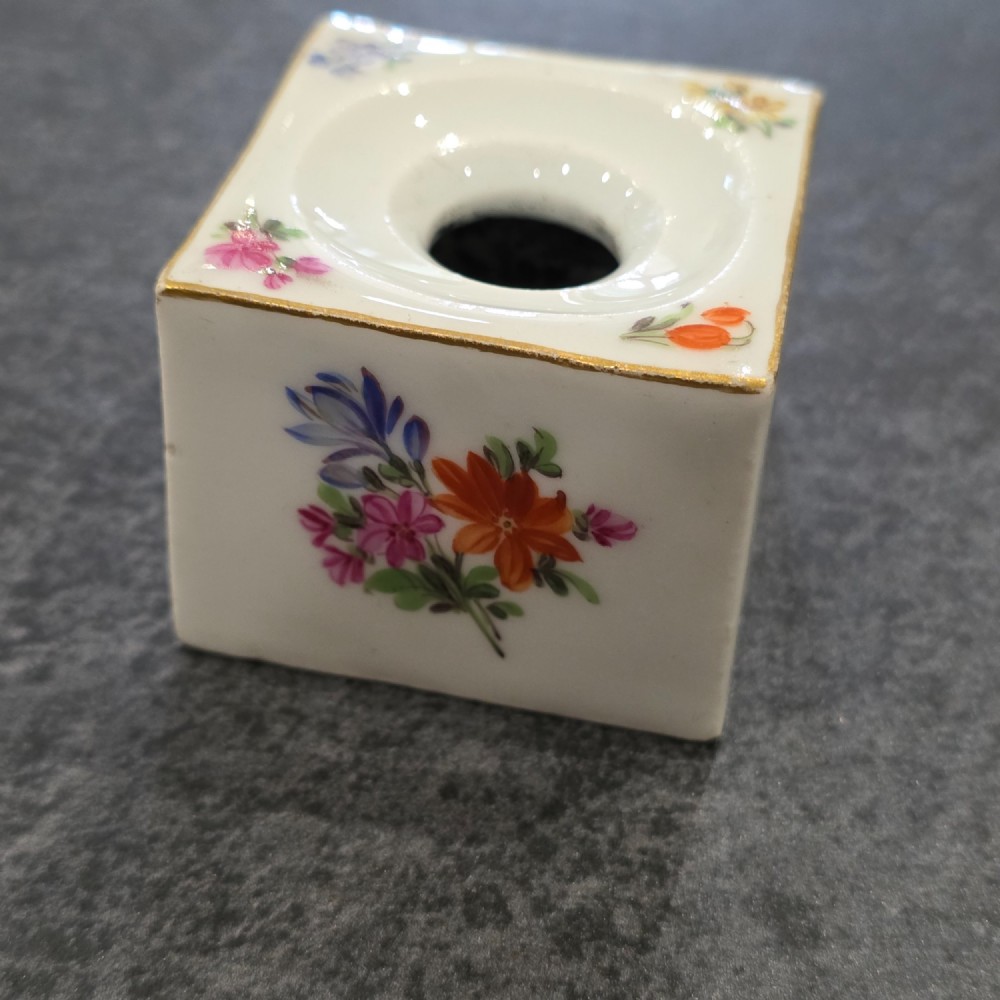 A square white porcelain inkwell featuring a recessed circular top, hand-painted botanical flowers on the sides, and a gold gilded rim. View VIII