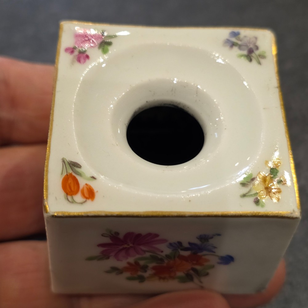 A square white porcelain inkwell featuring a recessed circular top, hand-painted botanical flowers on the sides, and a gold gilded rim. View X