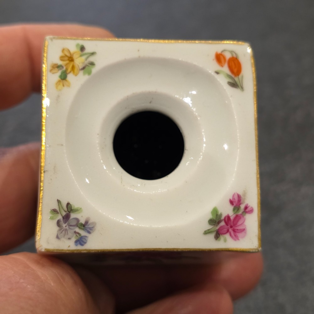 A square white porcelain inkwell featuring a recessed circular top, hand-painted botanical flowers on the sides, and a gold gilded rim. View XII
