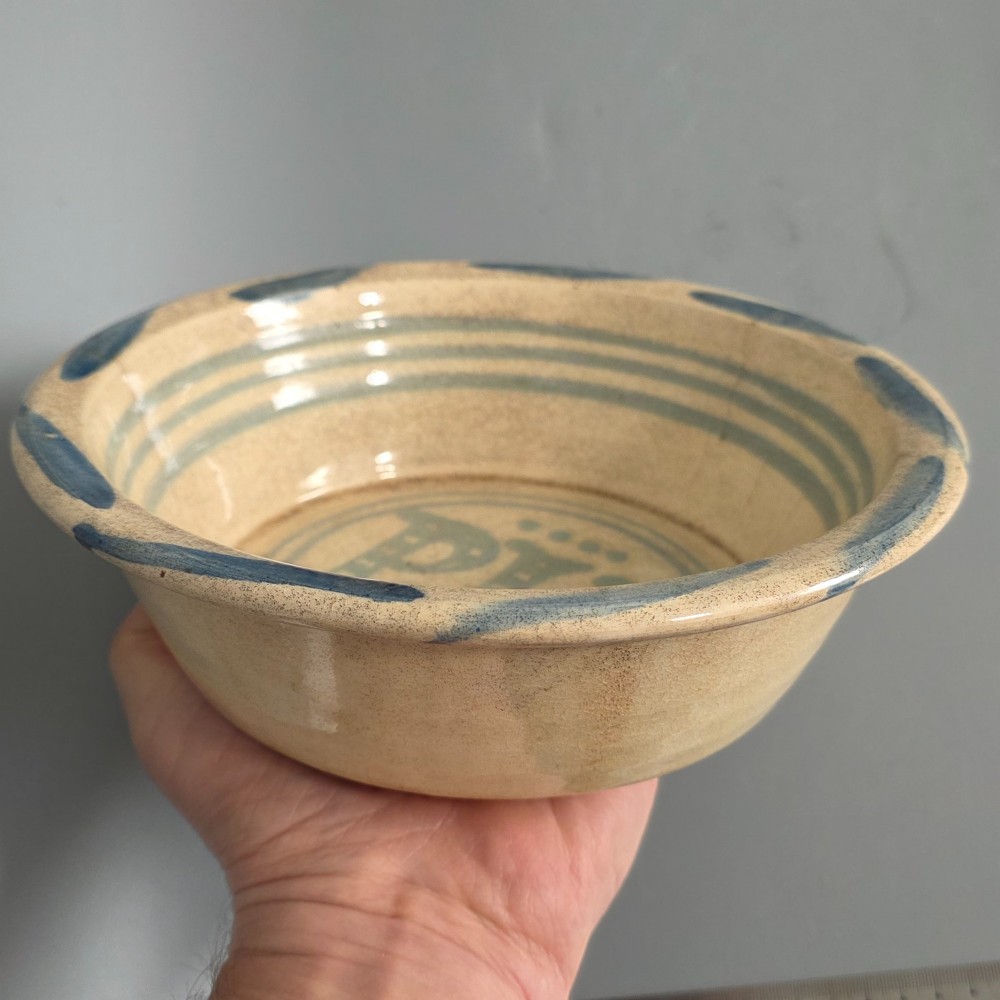 A circular nineteenth-century cream earthenware pie dish featuring the word PIE in blue lettering at the centre and blue decorative rim slashes. View VI