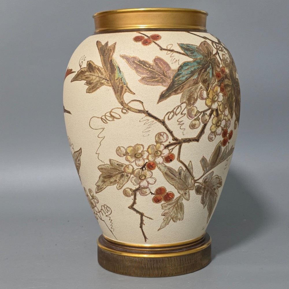 A large cream ceramic vase adorned with hand-painted botanical vines, foliage, berries, and gilded accents. View IV