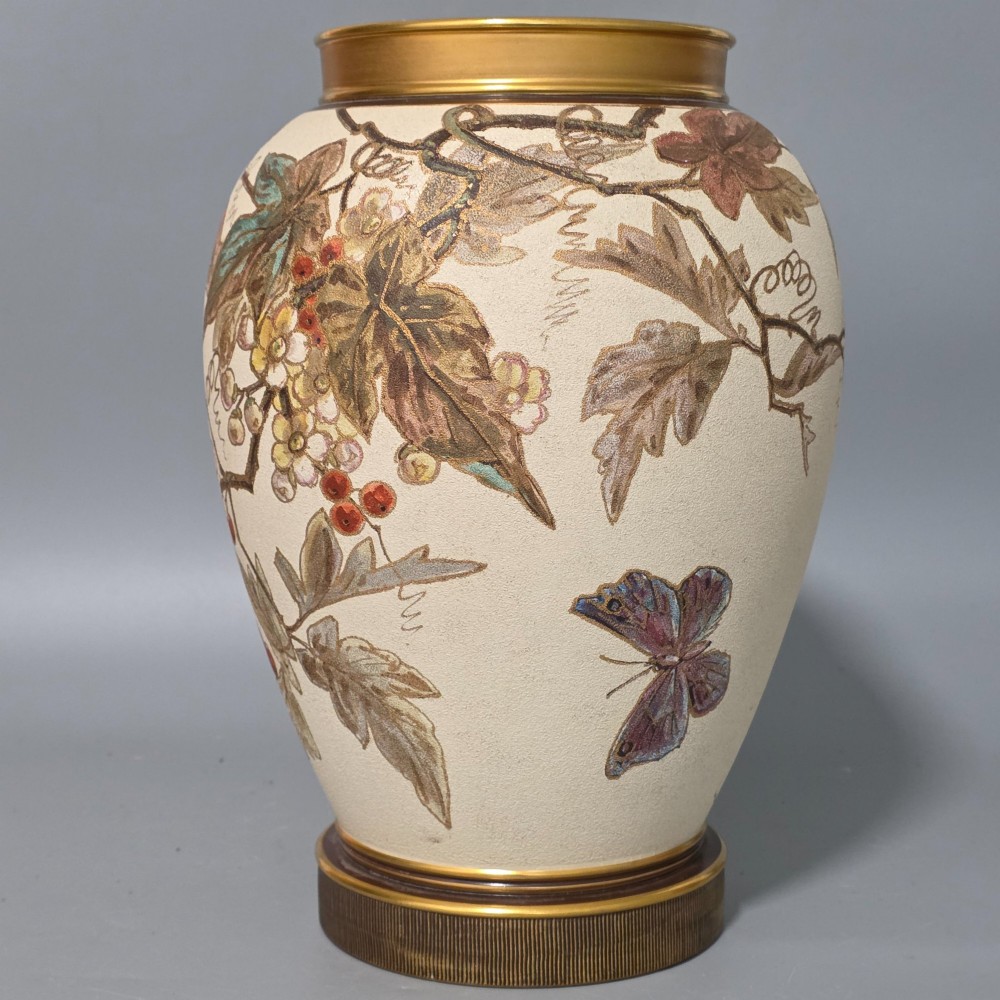 A large cream ceramic vase adorned with hand-painted botanical vines, foliage, berries, and gilded accents. View V