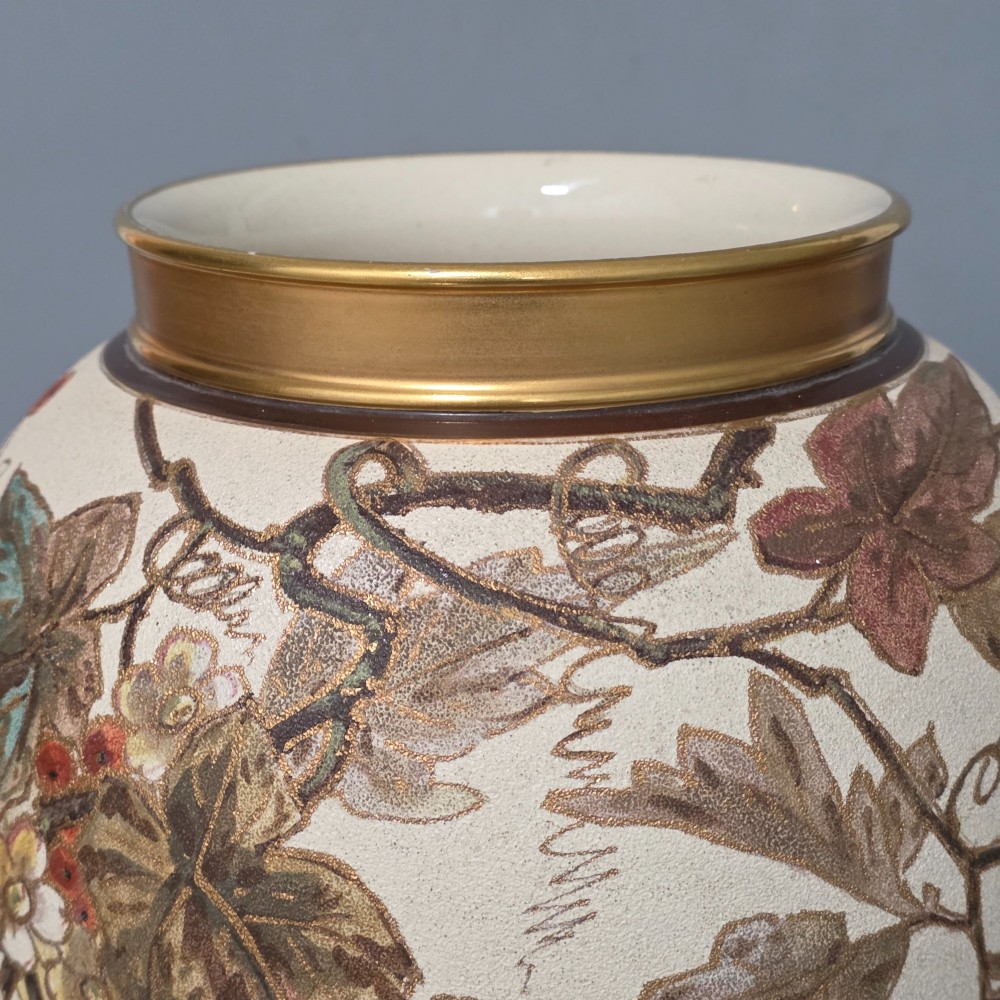 A large cream ceramic vase adorned with hand-painted botanical vines, foliage, berries, and gilded accents. View VI