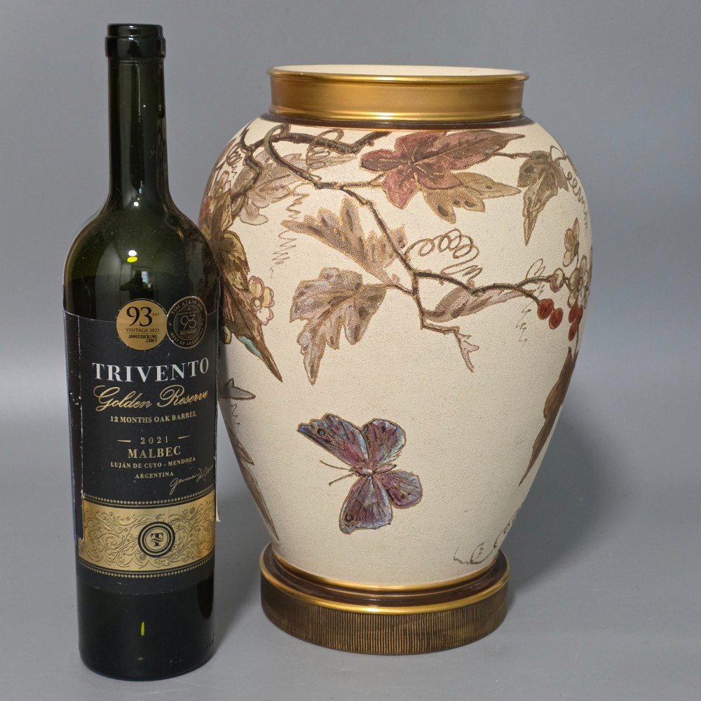 A large cream ceramic vase adorned with hand-painted botanical vines, foliage, berries, and gilded accents. View X