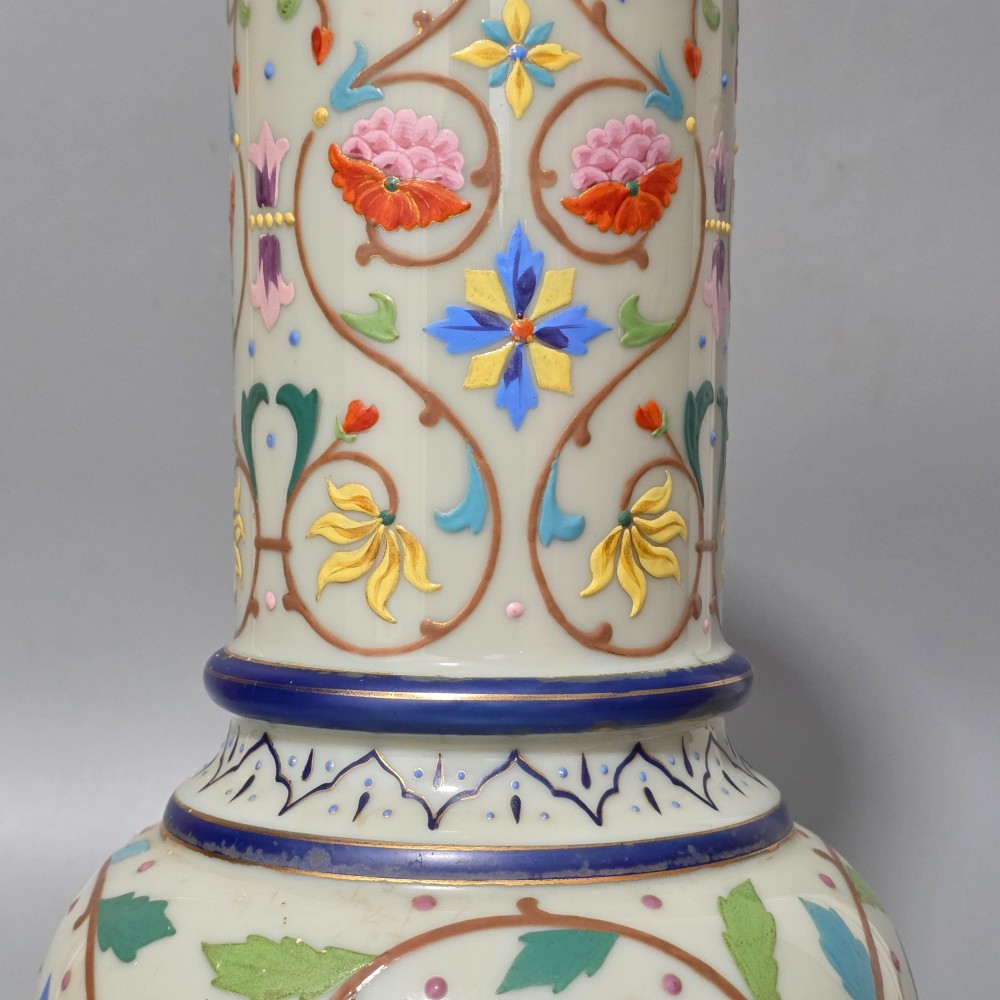 An antique cream opaque glass vase featuring hand-painted floral arabesque enamel patterns in bright colours with gilded accents and cobalt blue bands. View VIII