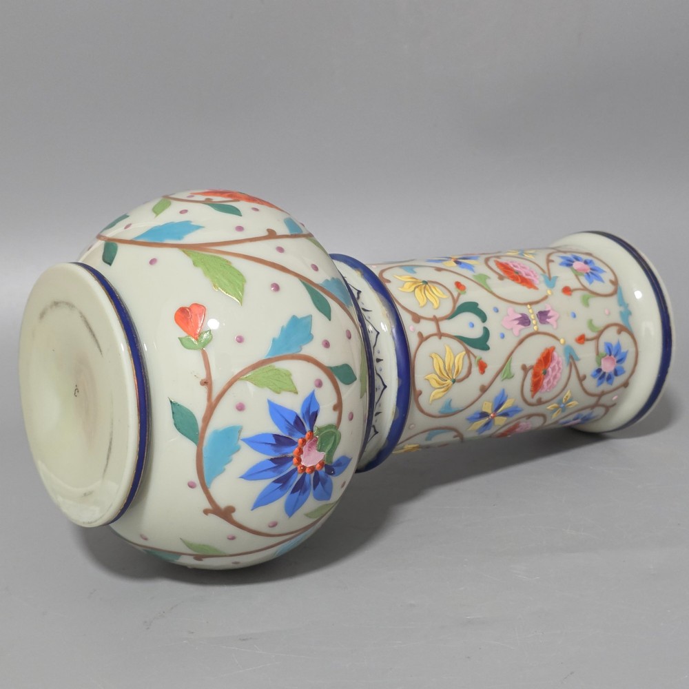 An antique cream opaque glass vase featuring hand-painted floral arabesque enamel patterns in bright colours with gilded accents and cobalt blue bands. View XIV