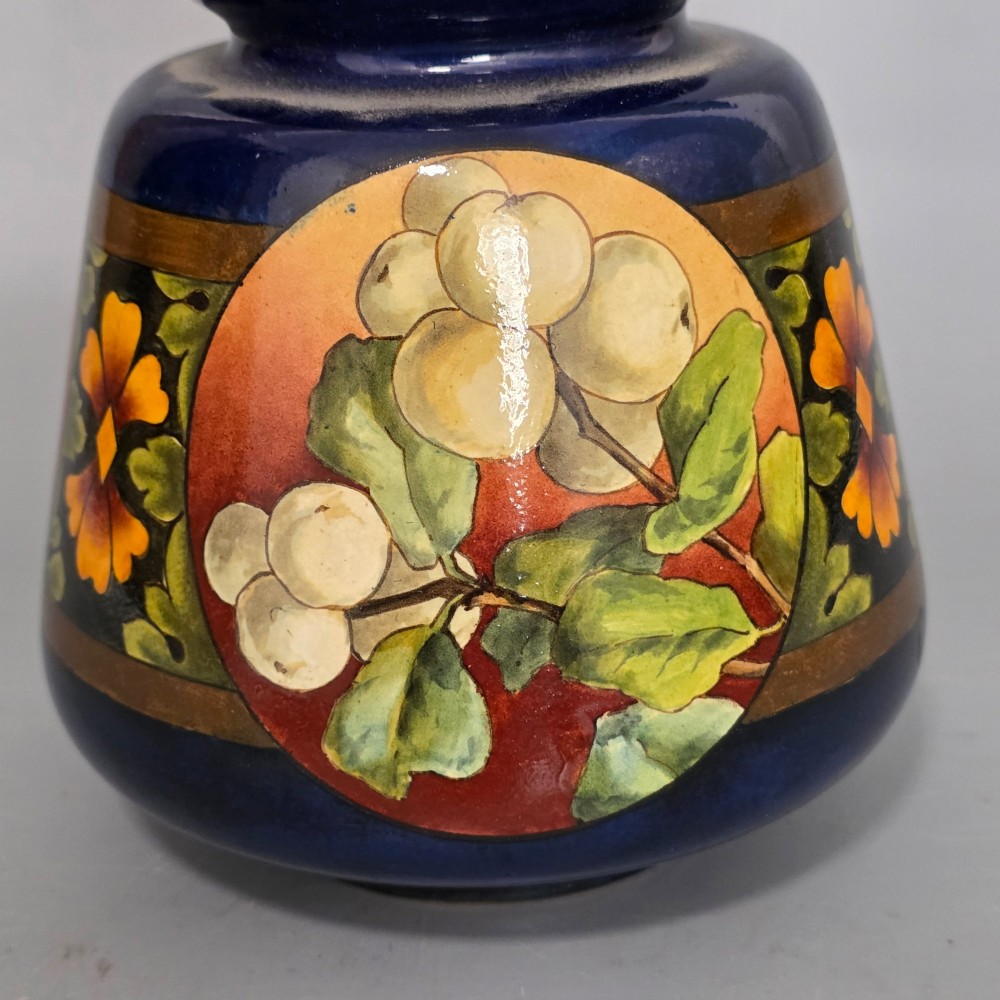 A late Victorian double-gourd earthenware vase with hand-painted fruit roundels, stylized floral bands, and a gradient turquoise to blue neck. View III