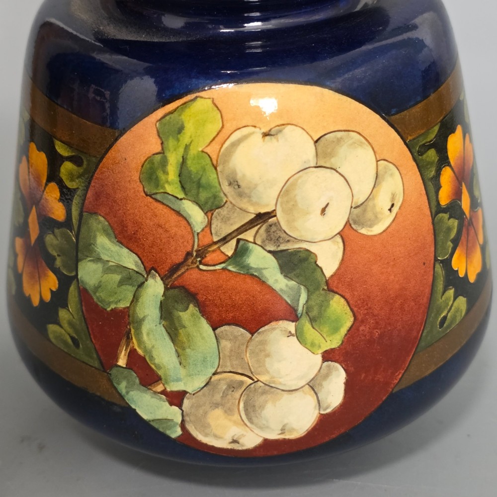 A late Victorian double-gourd earthenware vase with hand-painted fruit roundels, stylized floral bands, and a gradient turquoise to blue neck. View IV