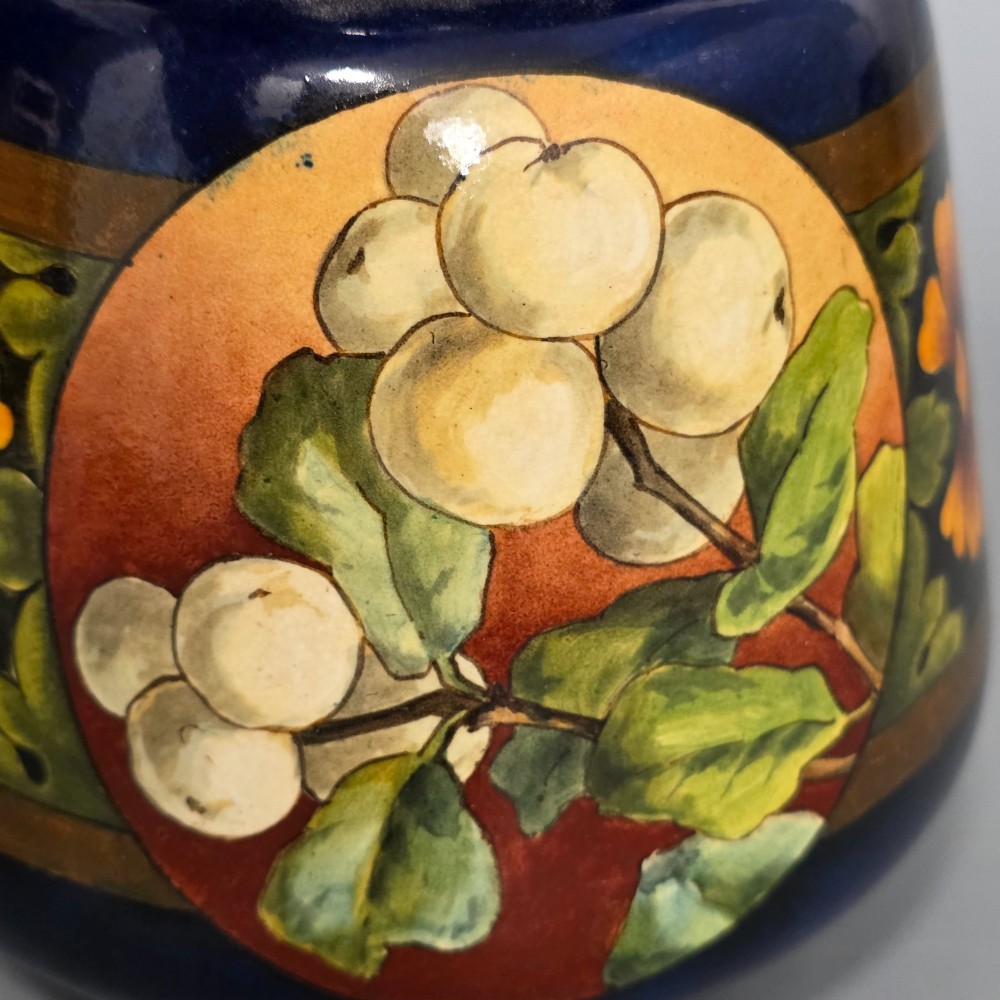A late Victorian double-gourd earthenware vase with hand-painted fruit roundels, stylized floral bands, and a gradient turquoise to blue neck. View VI