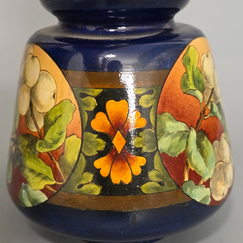 A late Victorian double-gourd earthenware vase with hand-painted fruit roundels, stylized floral bands, and a gradient turquoise to blue neck. View VIII