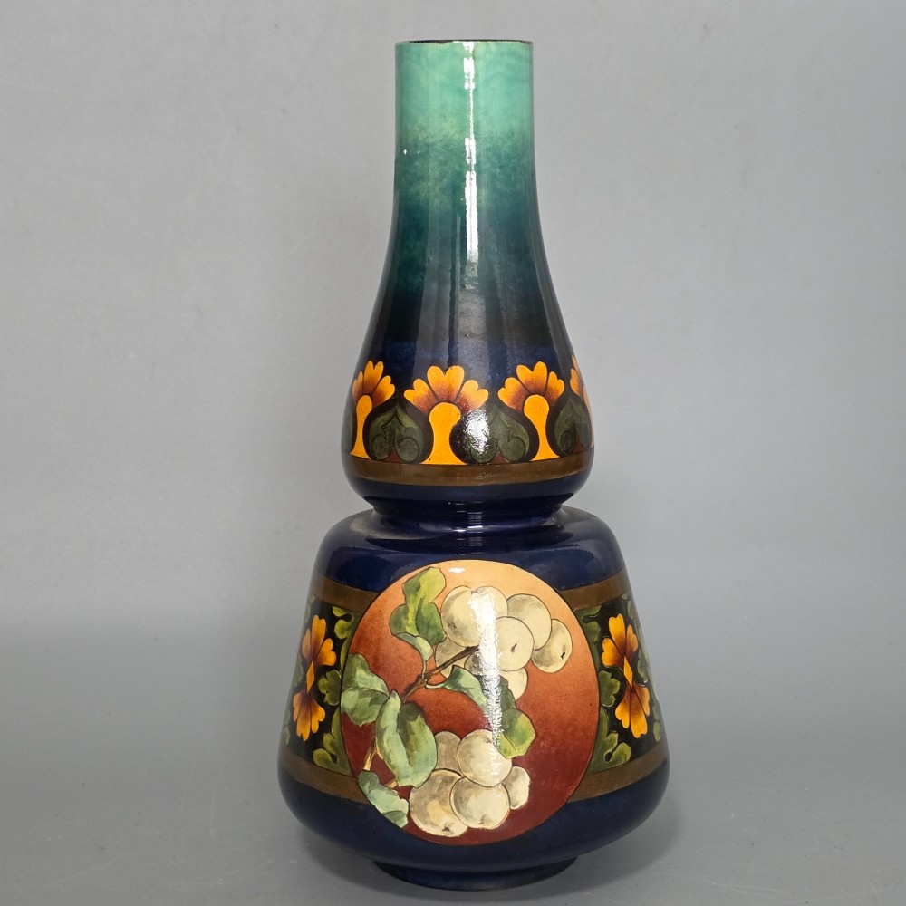 A late Victorian double-gourd earthenware vase with hand-painted fruit roundels, stylized floral bands, and a gradient turquoise to blue neck. View X