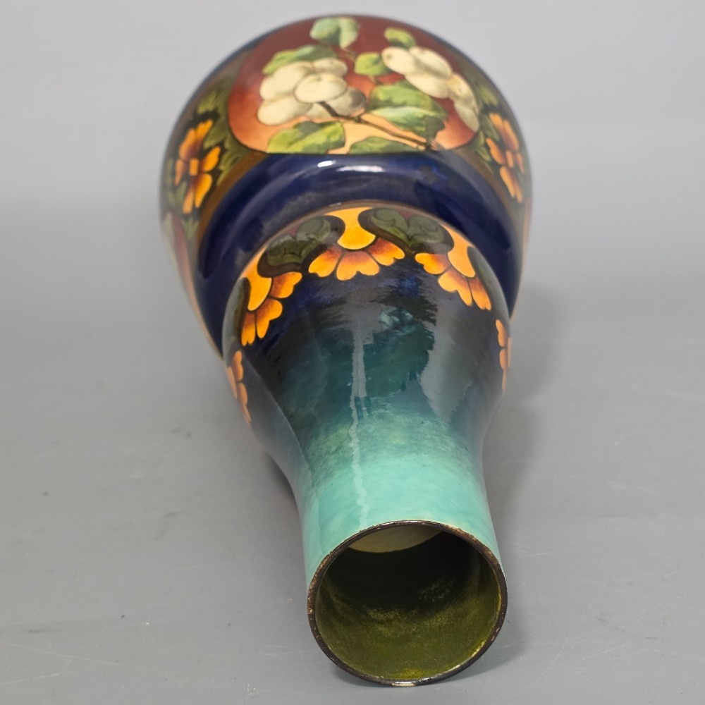 A late Victorian double-gourd earthenware vase with hand-painted fruit roundels, stylized floral bands, and a gradient turquoise to blue neck. View XII
