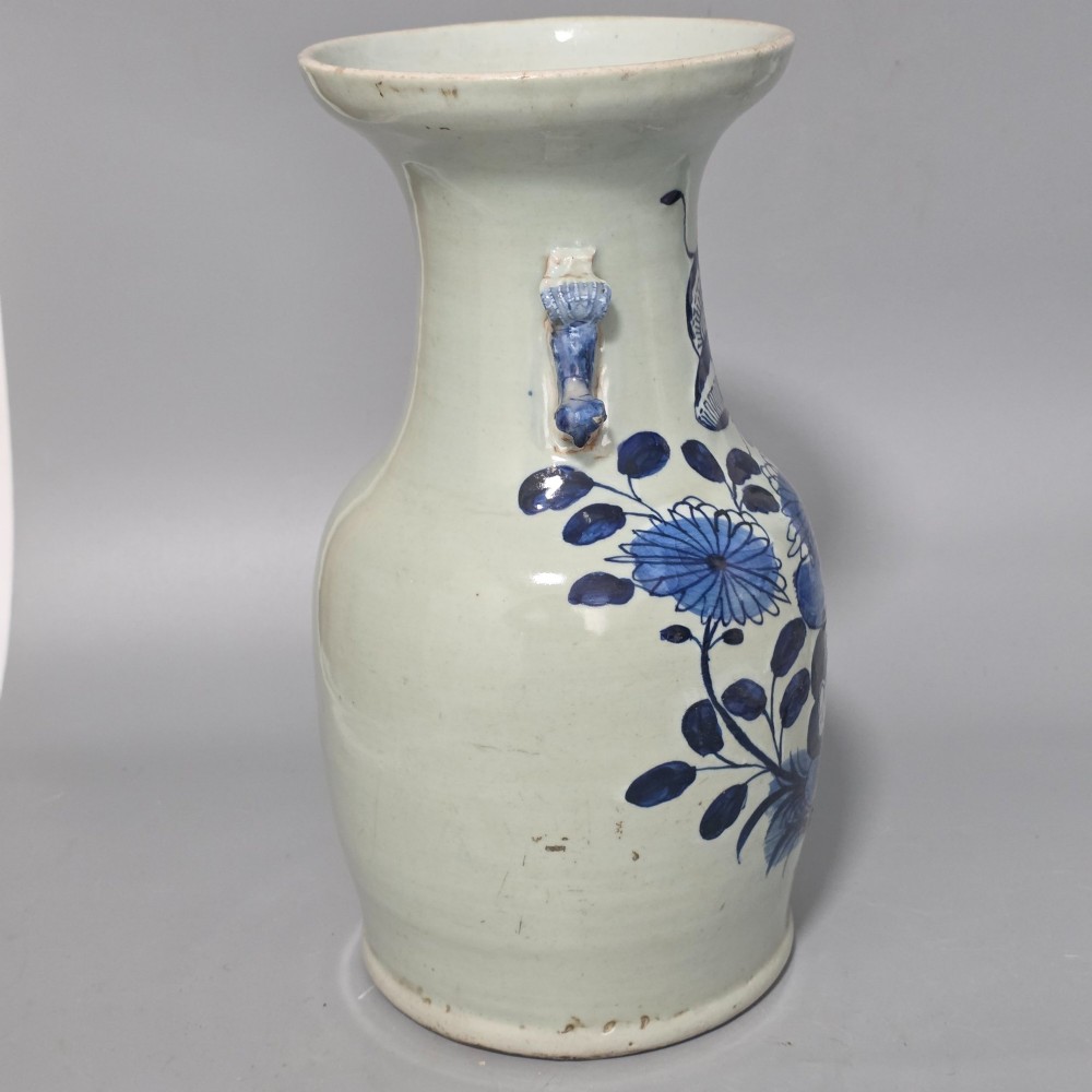 A 19th-century Chinese baluster porcelain vase featuring a pale celadon glaze decorated with hand-painted cobalt blue floral motifs and moulded neck handles. View II