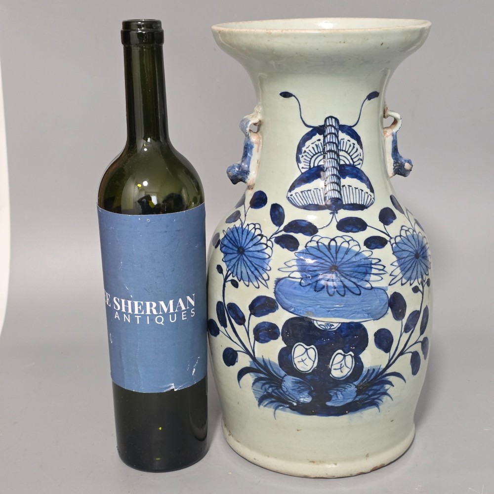 A 19th-century Chinese baluster porcelain vase featuring a pale celadon glaze decorated with hand-painted cobalt blue floral motifs and moulded neck handles. View V