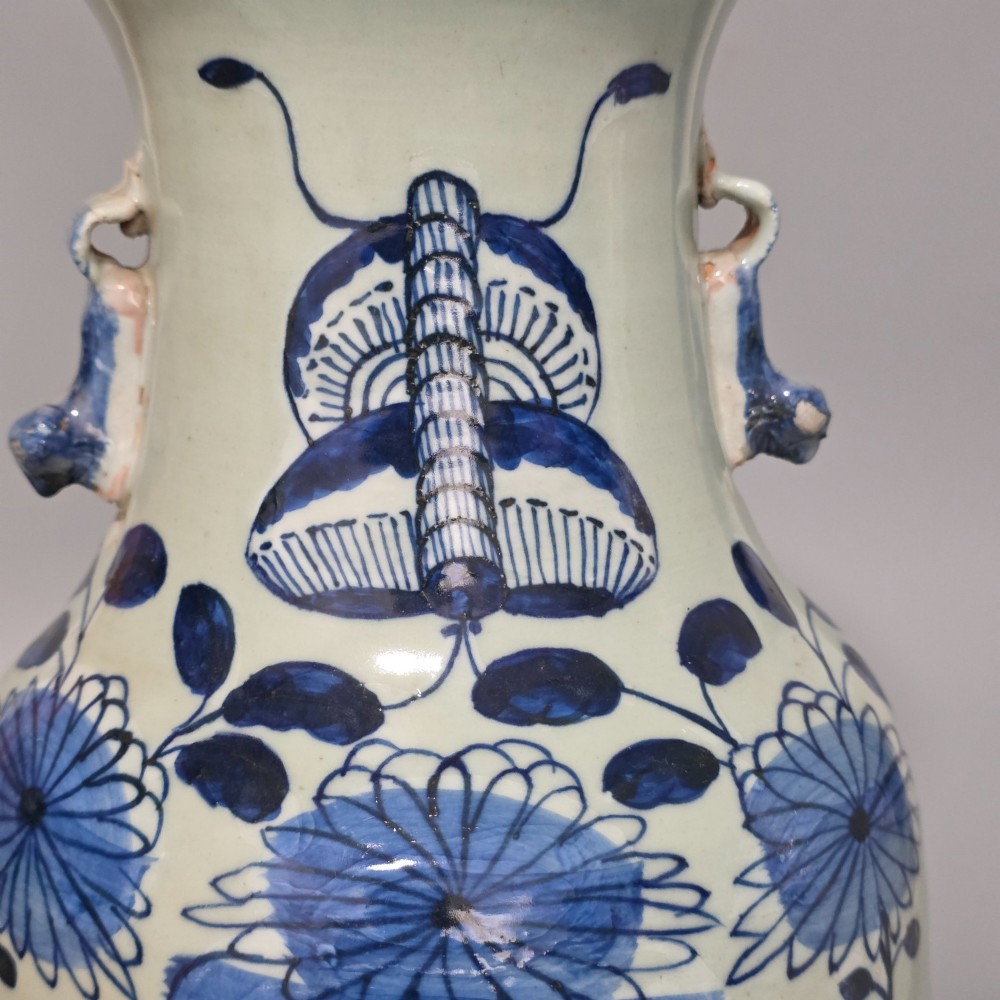 A 19th-century Chinese baluster porcelain vase featuring a pale celadon glaze decorated with hand-painted cobalt blue floral motifs and moulded neck handles. View VI