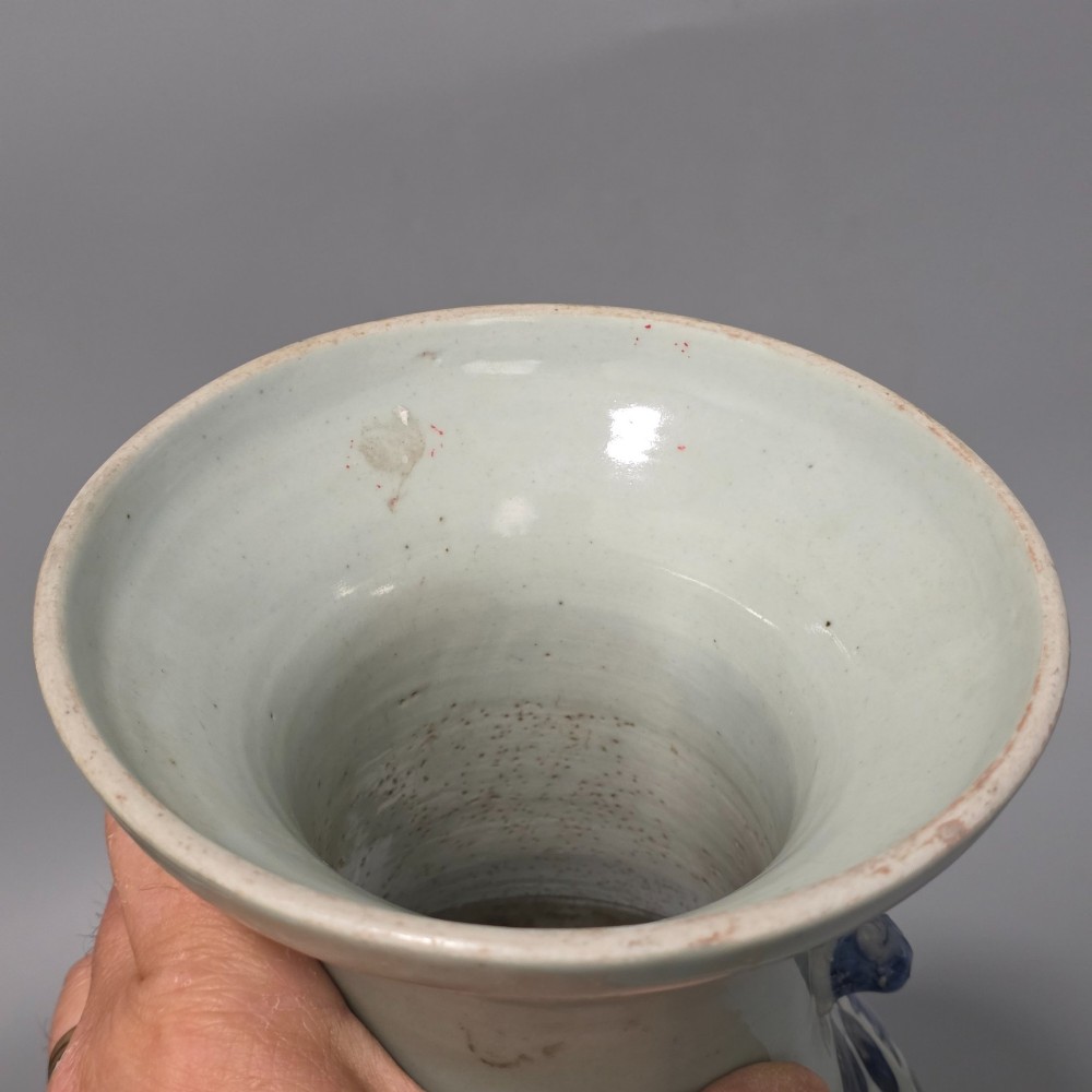 A 19th-century Chinese baluster porcelain vase featuring a pale celadon glaze decorated with hand-painted cobalt blue floral motifs and moulded neck handles. View X