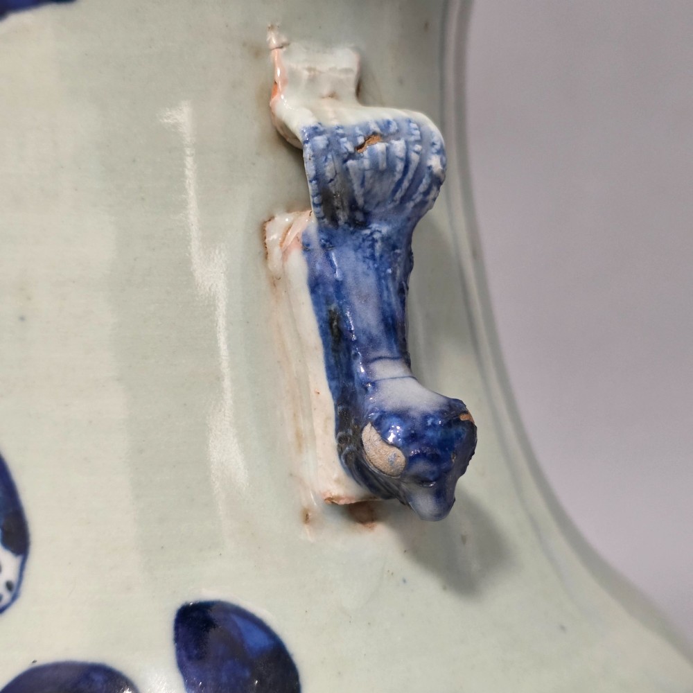A 19th-century Chinese baluster porcelain vase featuring a pale celadon glaze decorated with hand-painted cobalt blue floral motifs and moulded neck handles. View XII