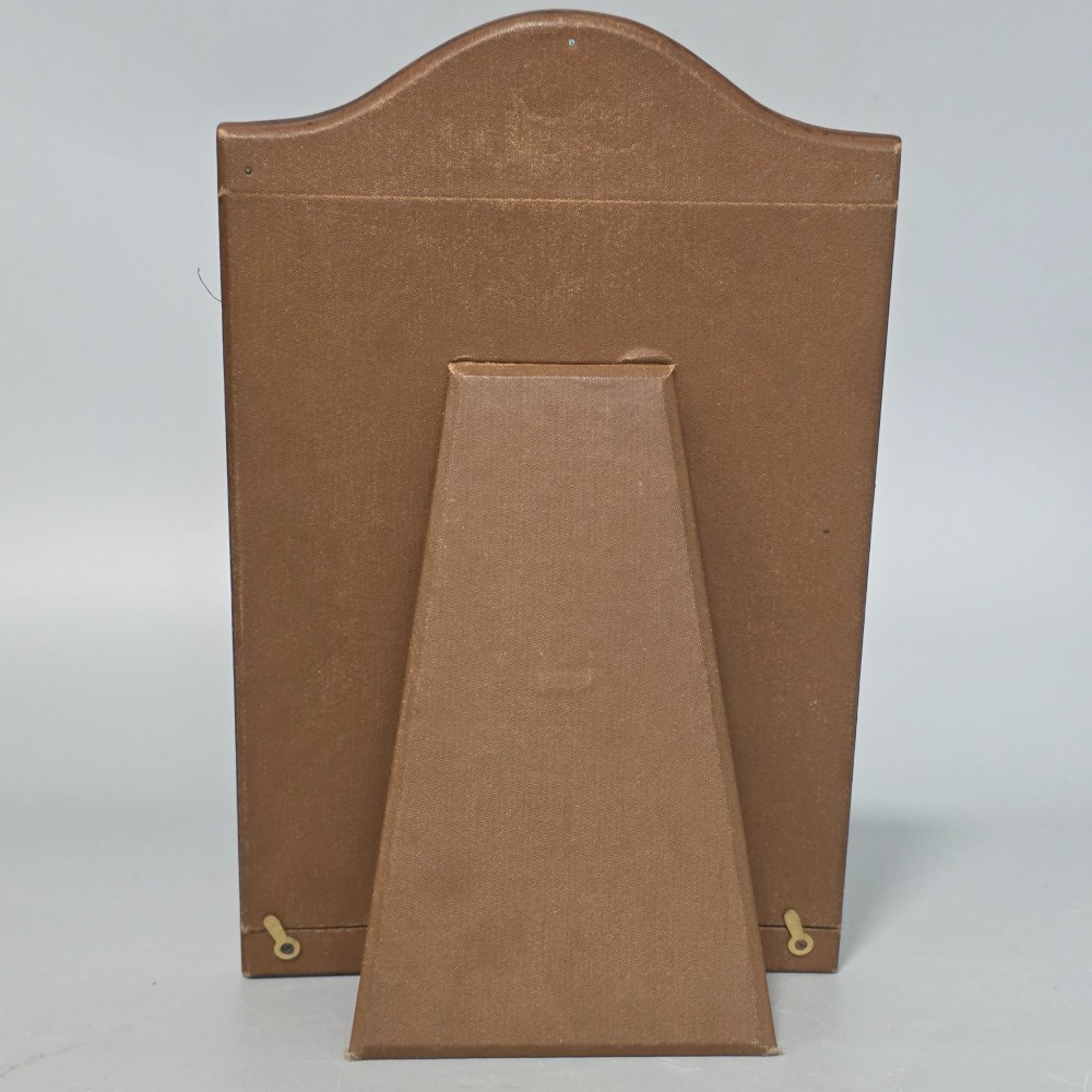 A dark brown leather desktop picture frame featuring an arched top decorated with a metal stag head emblem and motto scroll. View III