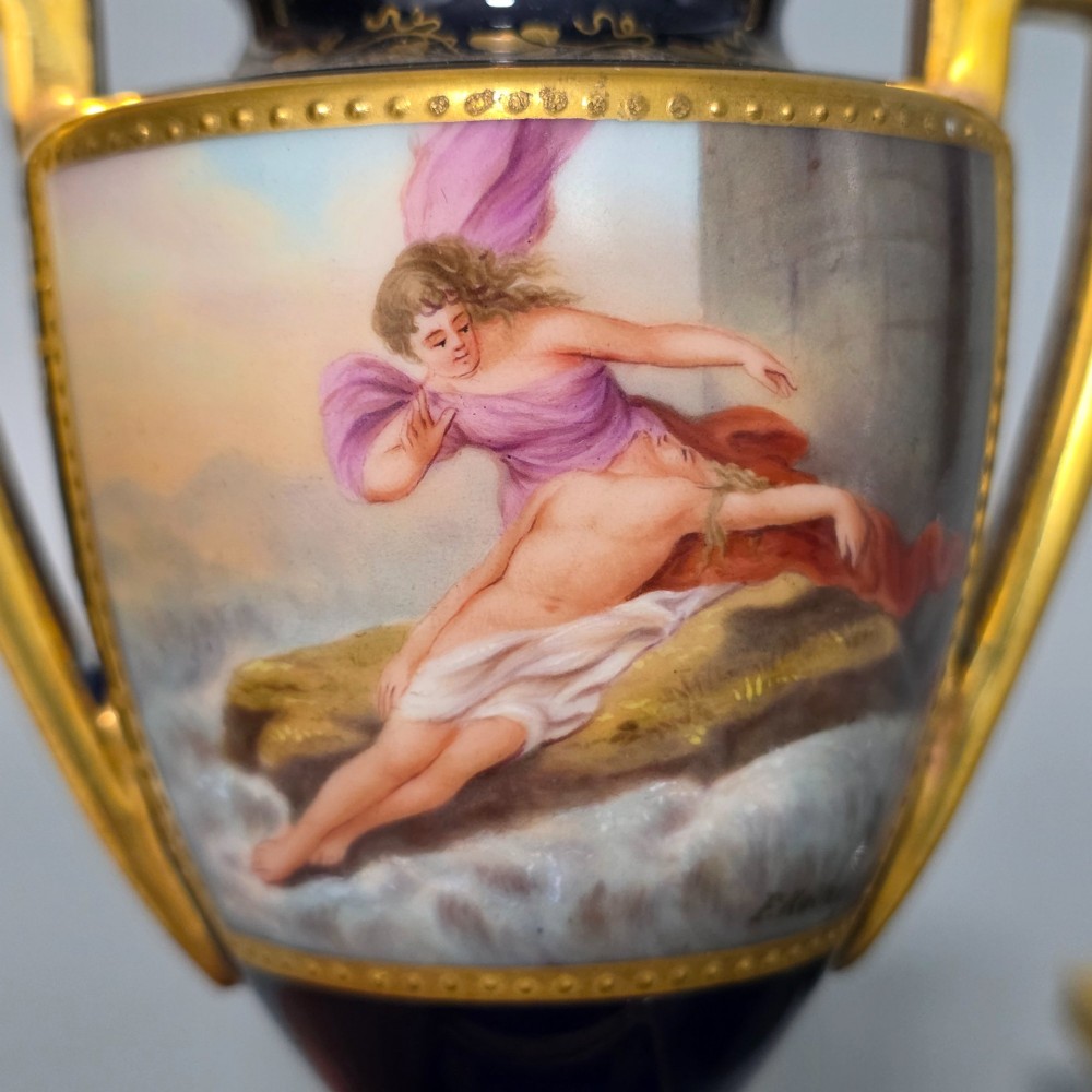 A pair of cobalt blue and gold Vienna porcelain Empire amphora vases featuring hand-painted classical figures and square plinth bases. View V