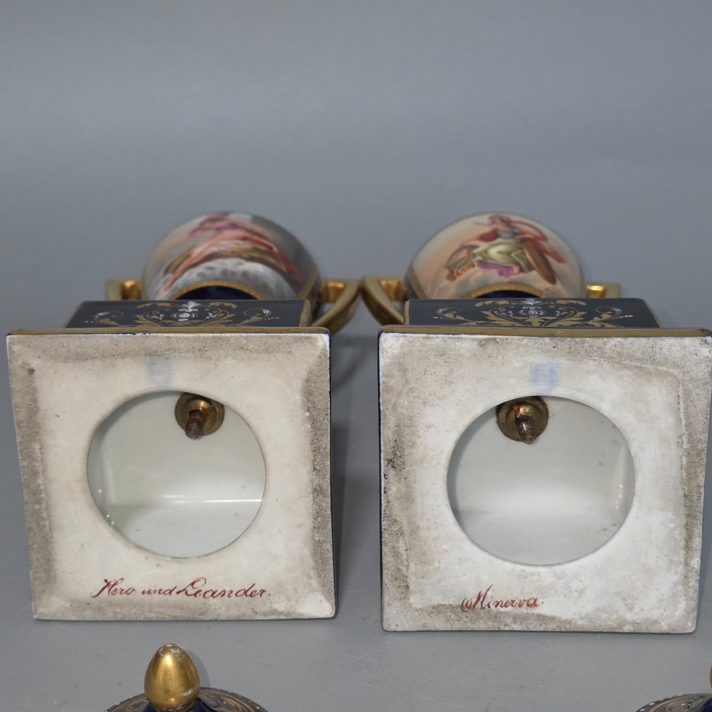 A pair of cobalt blue and gold Vienna porcelain Empire amphora vases featuring hand-painted classical figures and square plinth bases. View VIII