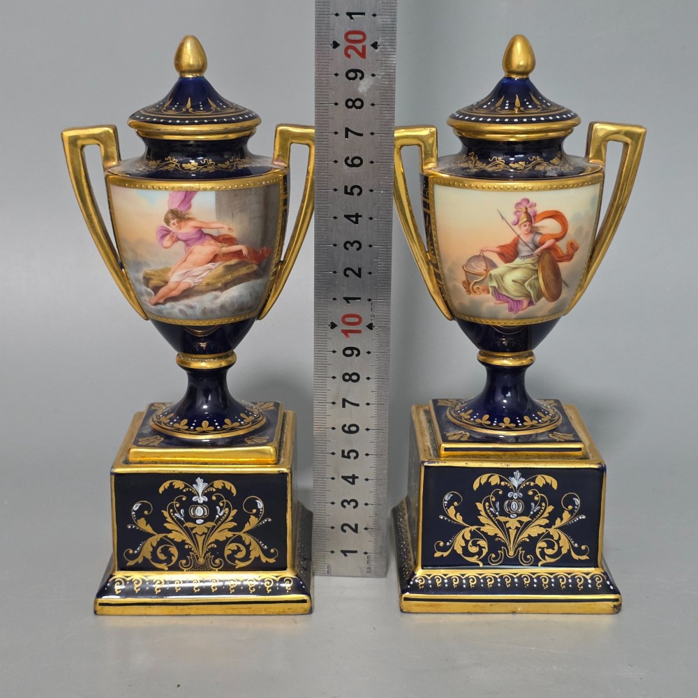 A pair of cobalt blue and gold Vienna porcelain Empire amphora vases featuring hand-painted classical figures and square plinth bases. View IX